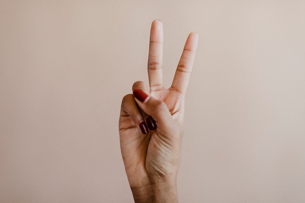 Woman showing a peace hand sign