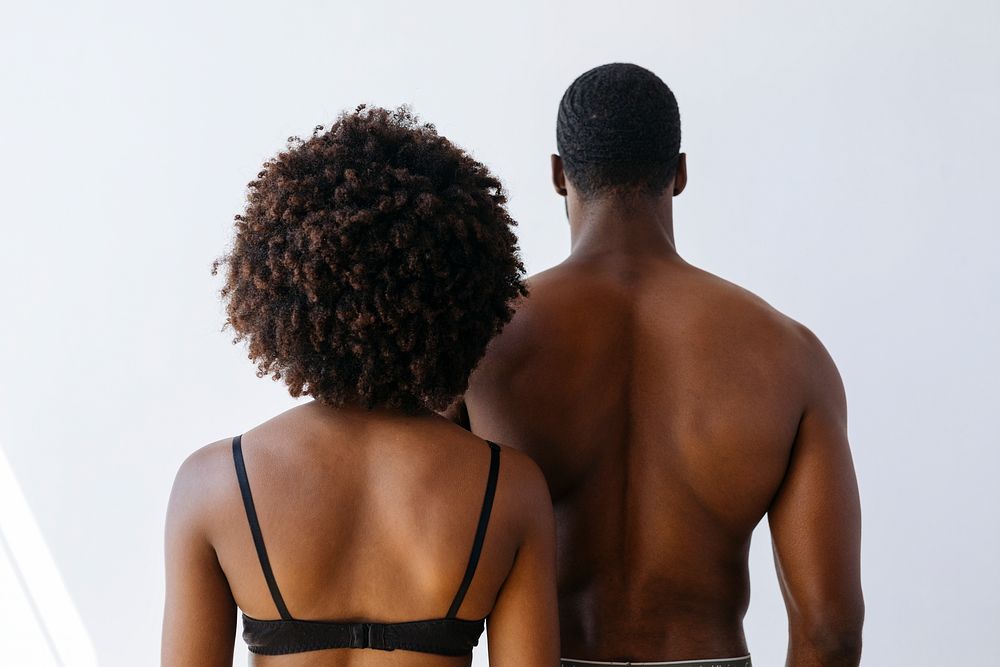 Rear view of seminude black couple