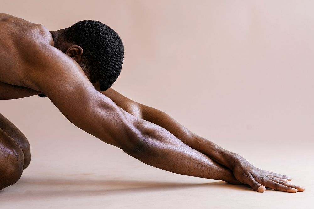 Naked black man warming up before exercise