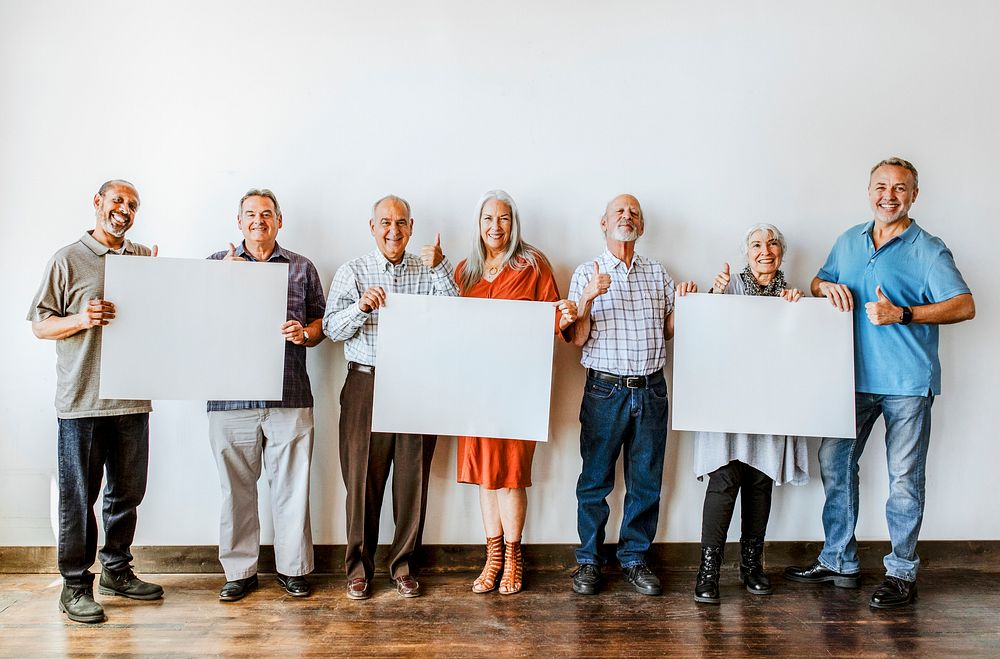 Elderly people holding blank posters