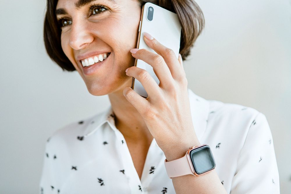 Woman wearing a smartwatch while talking on the phone