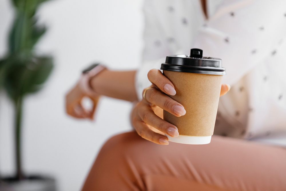 Woman holding a coffee cup mockup