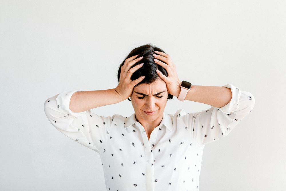 Stressed woman holding her forehead