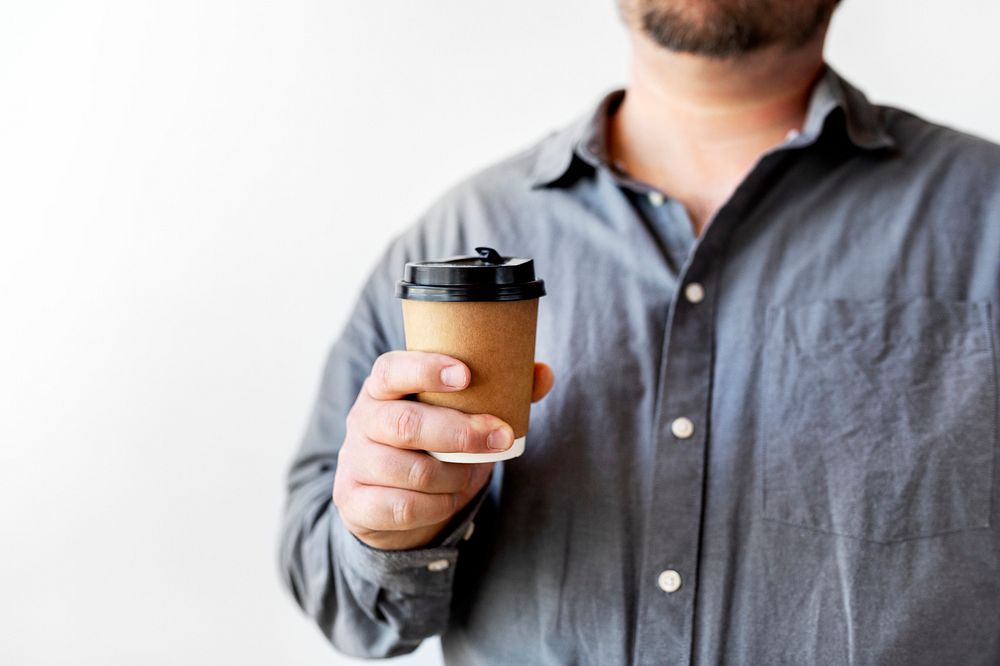 Man showing paper coffee cup