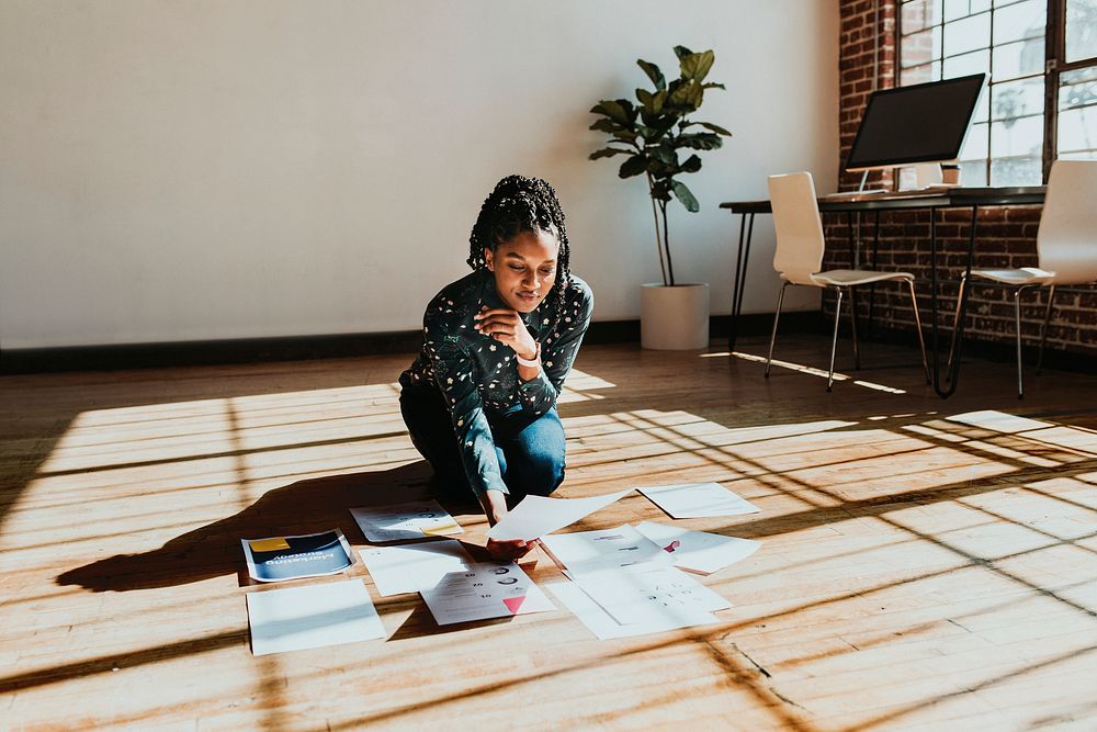 Businesswoman planning a marketing strategy on a wooden floor