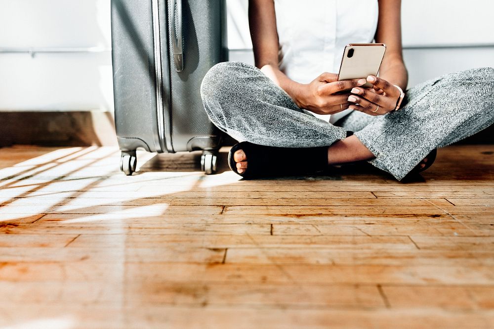 Sitting on the floor using smartphone