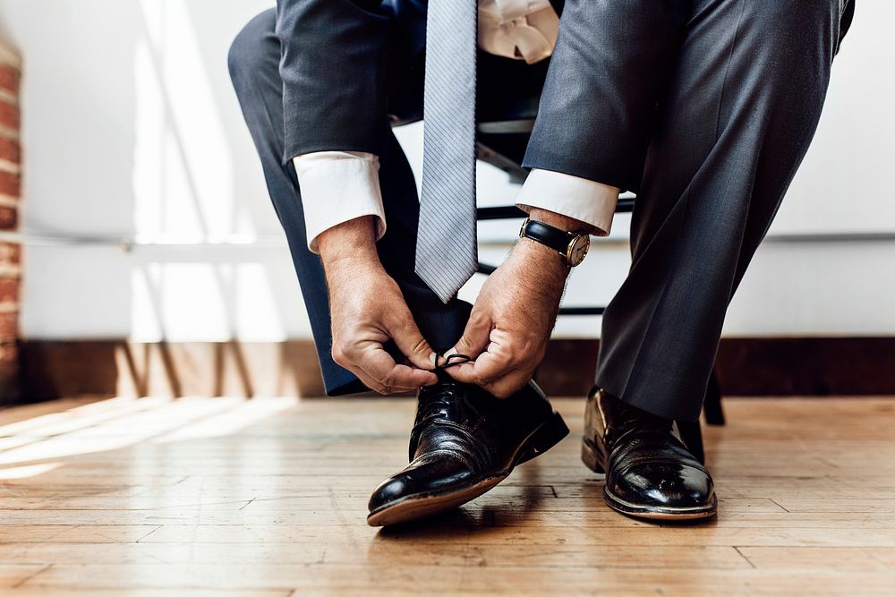 Businessman tying shoe lace before go to work