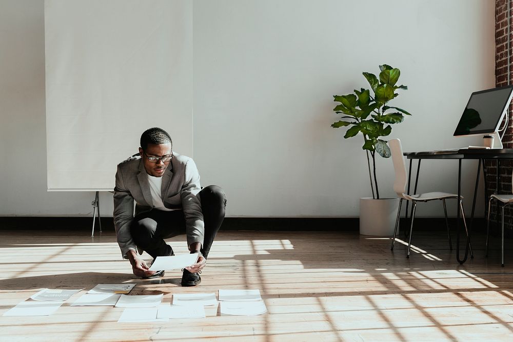 Businessman planning a marketing strategy on a wooden floor
