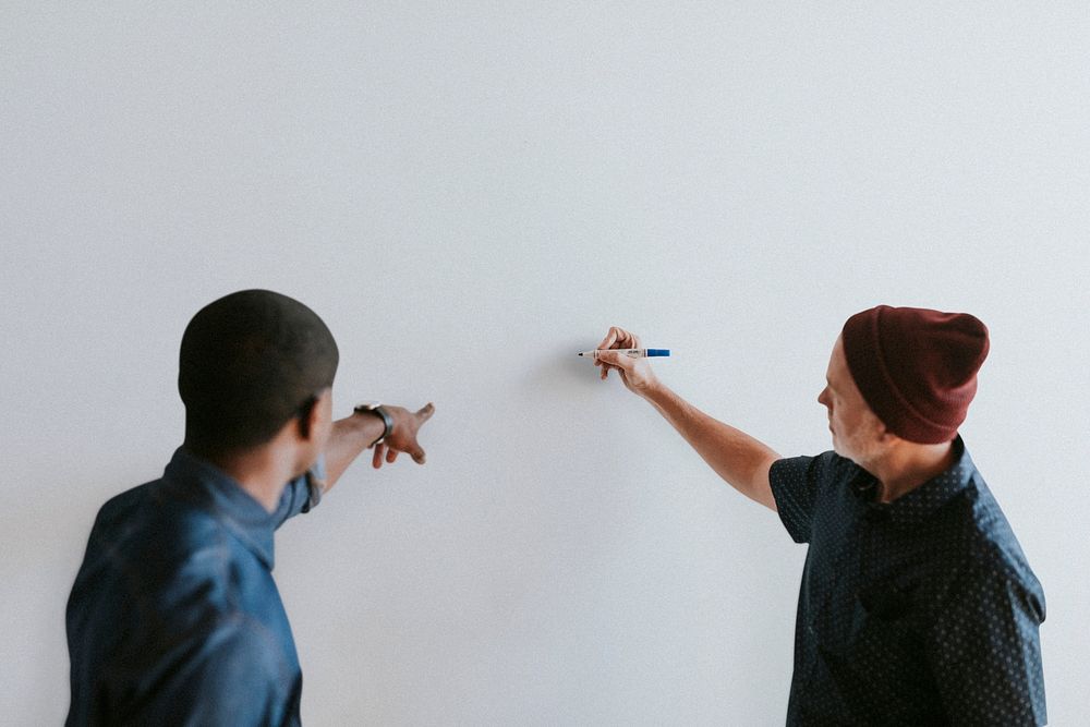 People writing on a white wall mockup