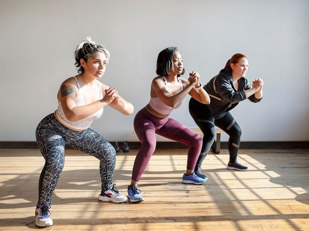 Women doing squats in fitness class