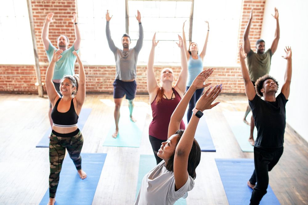 Trainer and her students in a Urdhva Hastasana pose