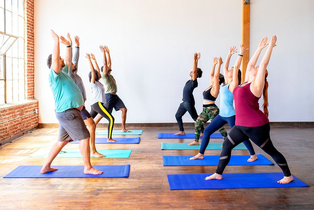 Trainer and her students in a Urdhva Hastasana pose