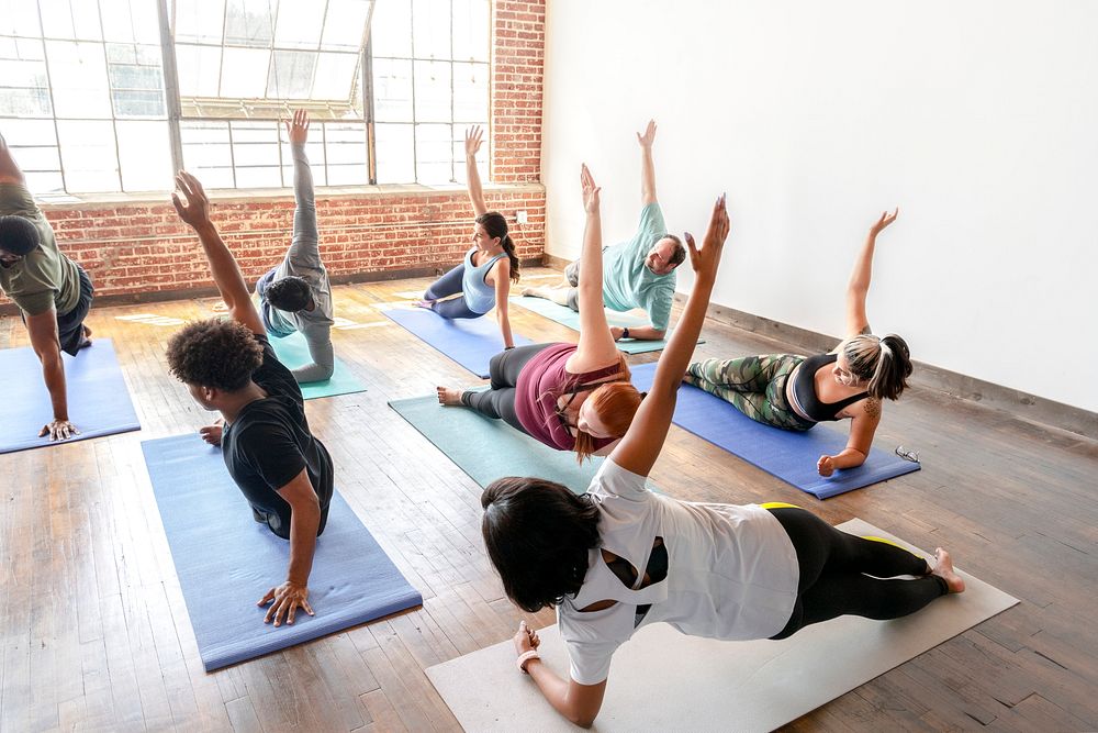 Trainer and her students in yoga pose