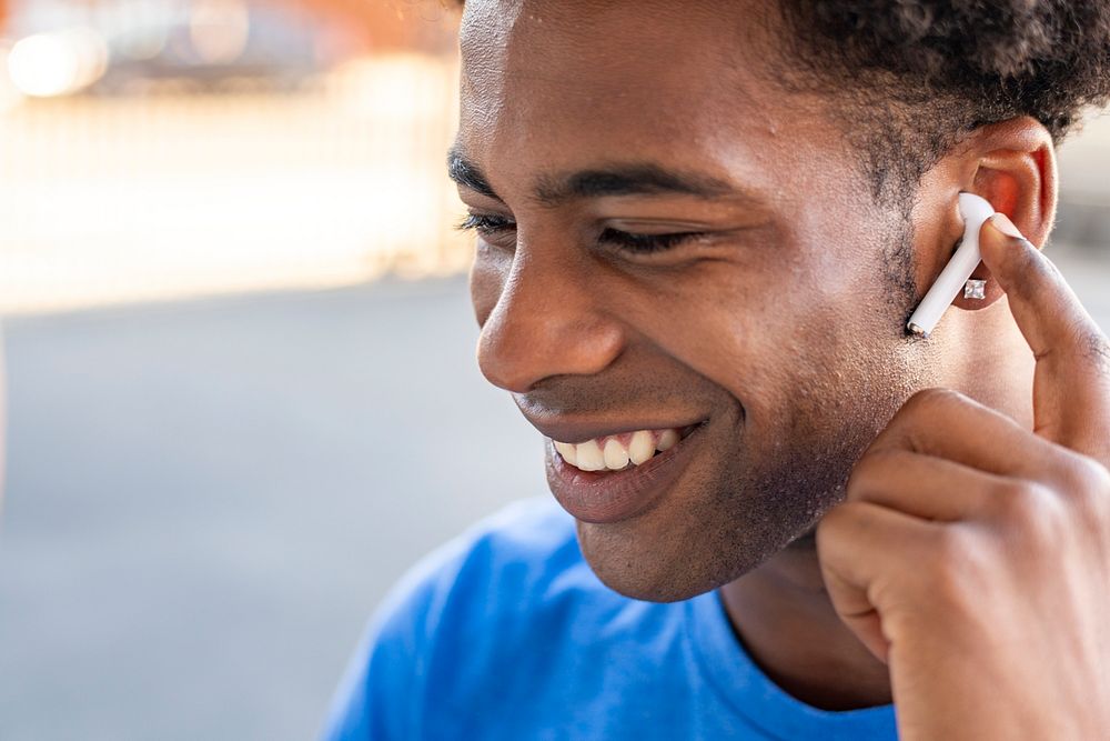 Man listening to music by wireless earphones