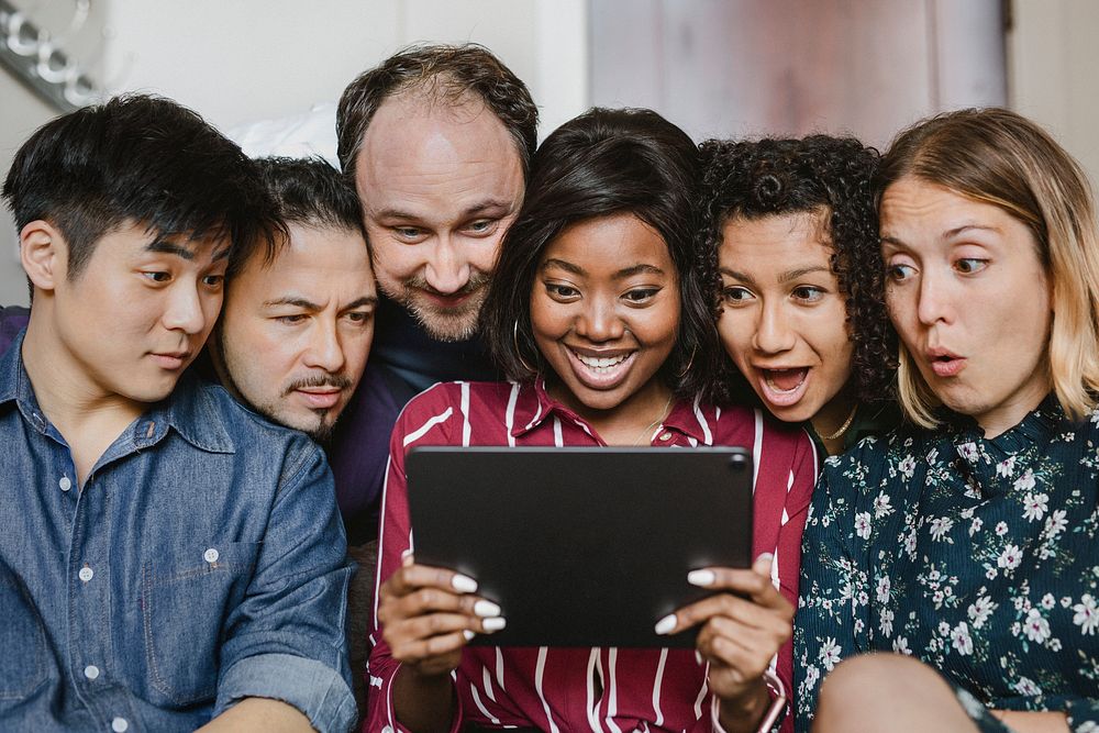Group of diverse business people watching a content on a digital tablet together