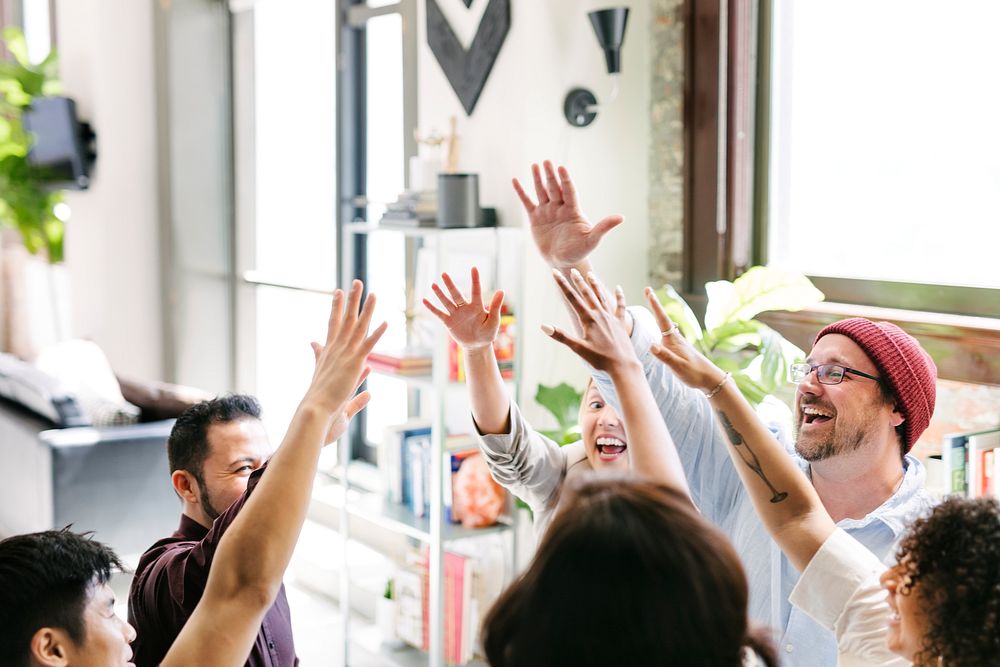 Happy diverse colleagues in a startup company doing a high five