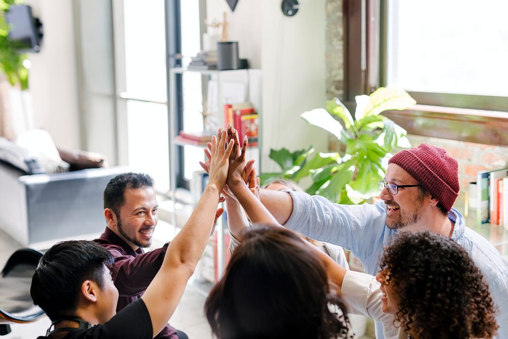 Happy diverse colleagues in a startup company doing a high five