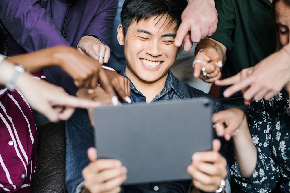 Group of diverse business people watching a content on a digital tablet together
