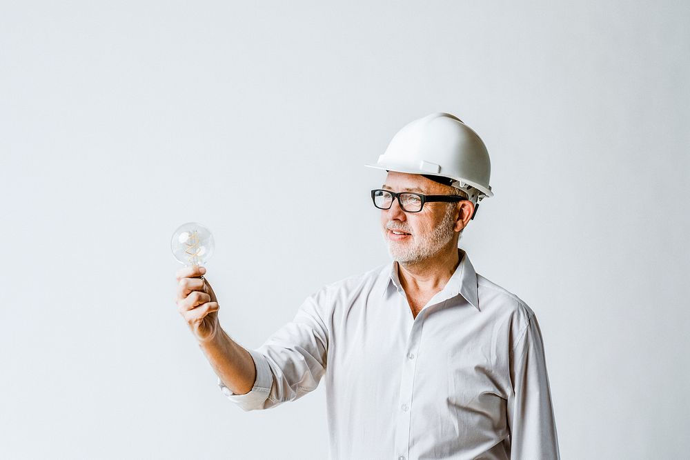 Senior engineer holding a light bulb