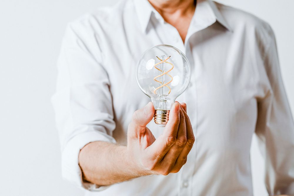 Creative man holding a light bulb