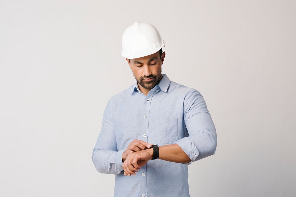 Man in a blue shirt using his smartwatch