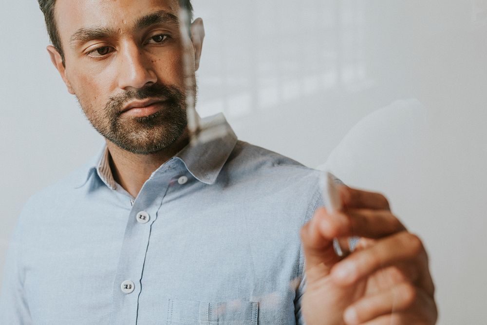 Mature man writing on an invisible screen