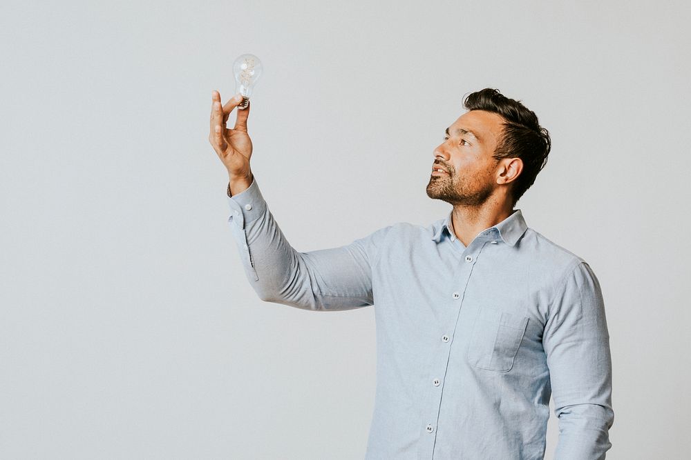 Creative man holding a light bulb
