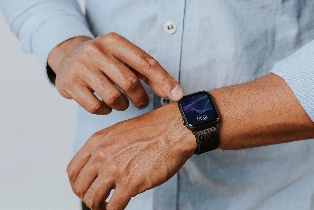 Man in a blue shirt using his smartwatch mockup