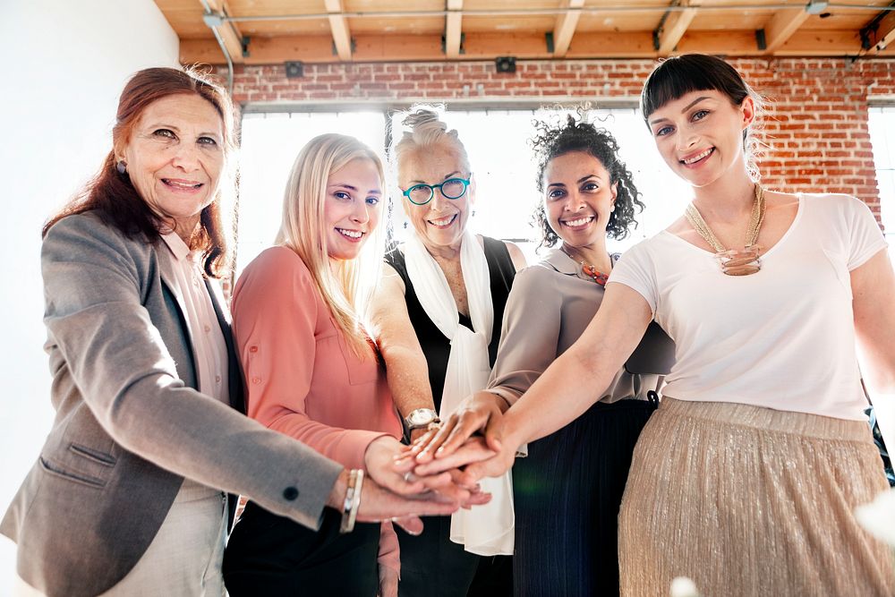 Women joining hands in the middle