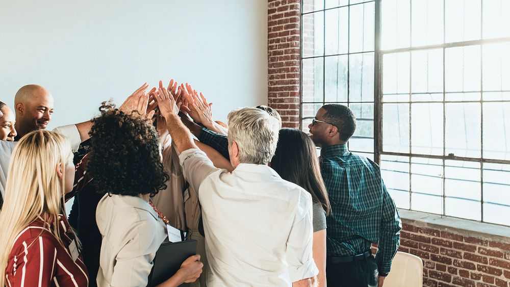 People joining hands in the air