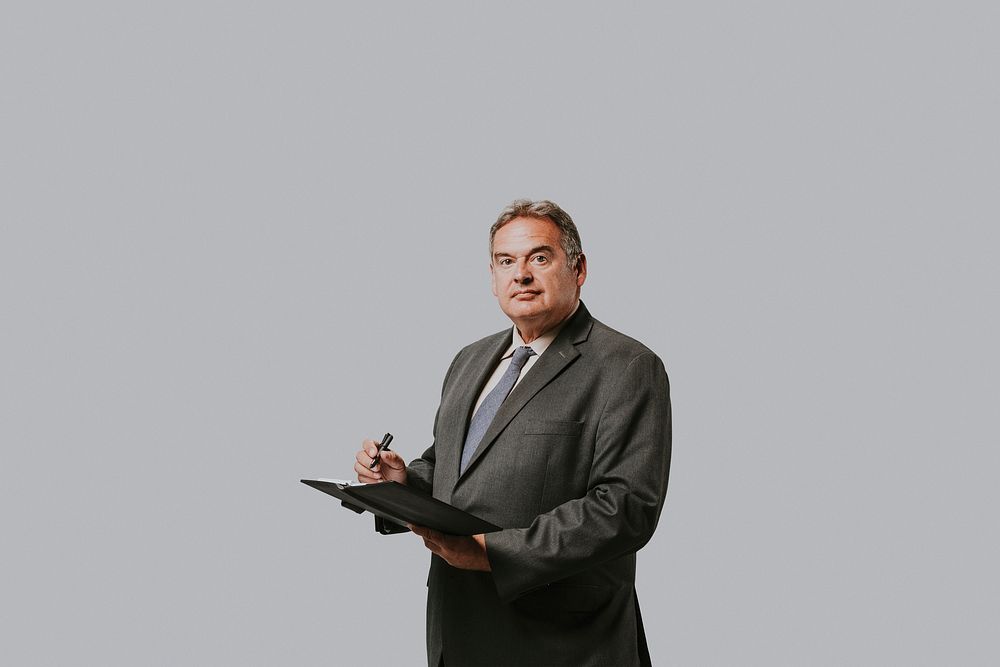 Businessman writing a note on a notebook