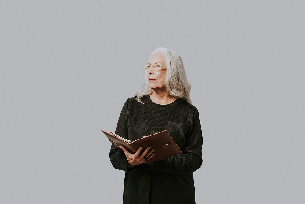 Senior businesswoman writing down on a notebook