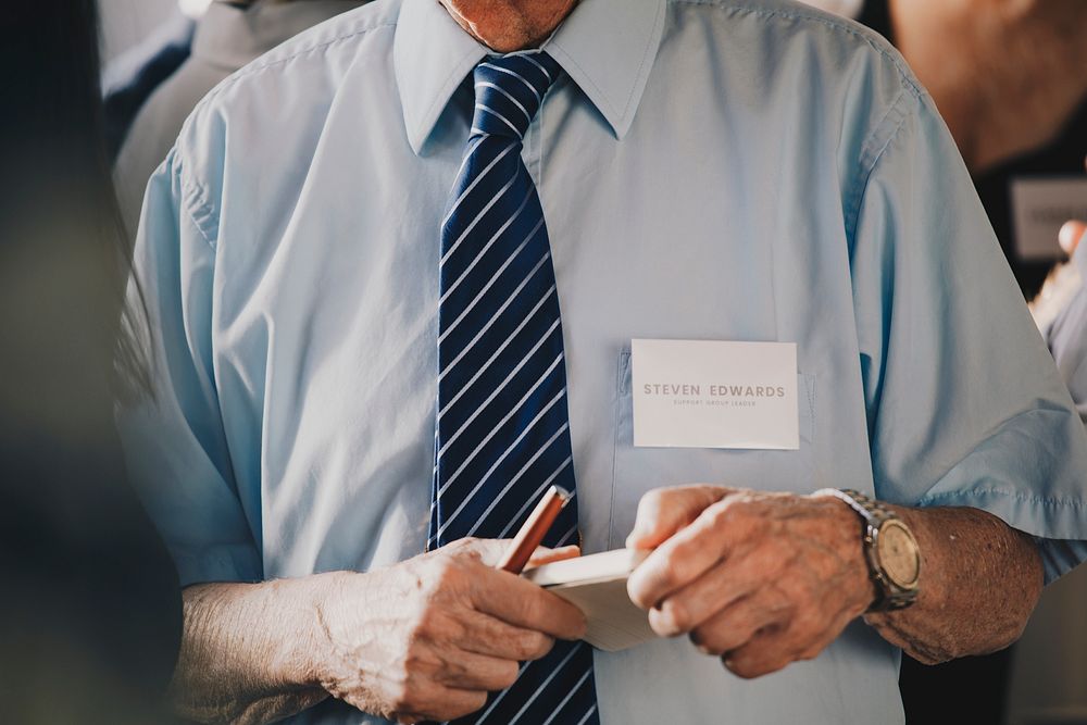 Businessman in a meeting holding a notebook and pen
