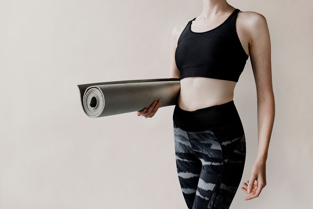 Sportive woman with a yoga mat mockup