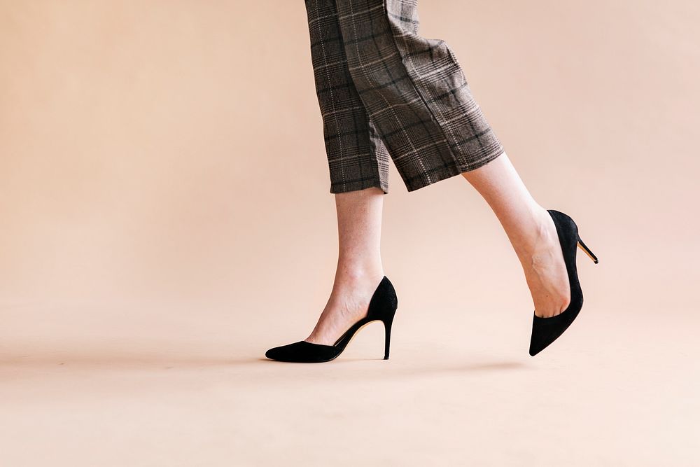 Fashionable woman in black shiny heels