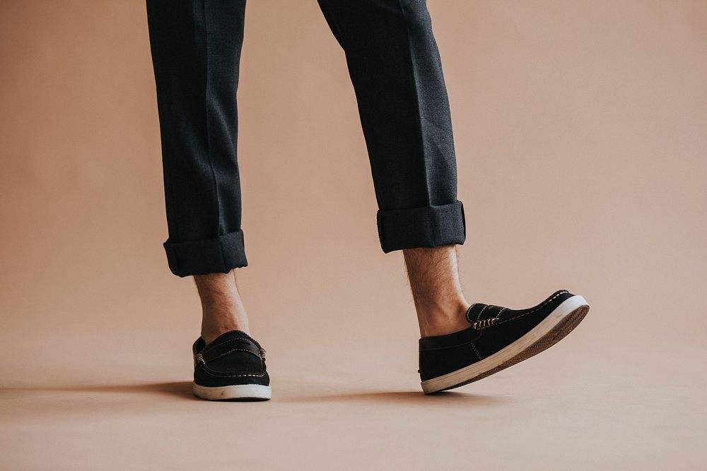 Man in a black pant and slip-on shoes