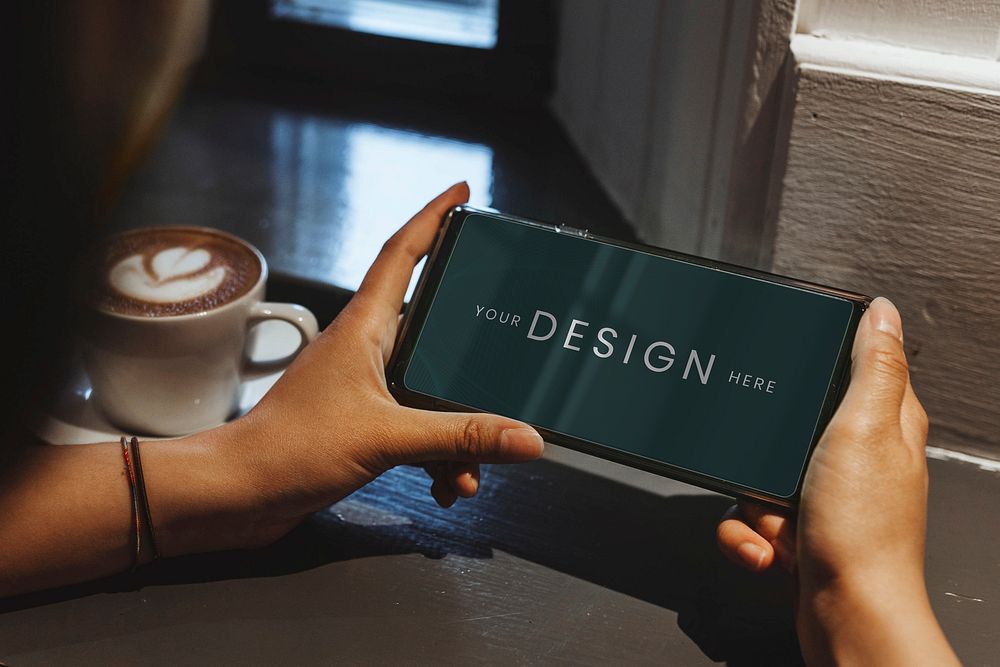 Woman in a cafe using a mobile phone mockup