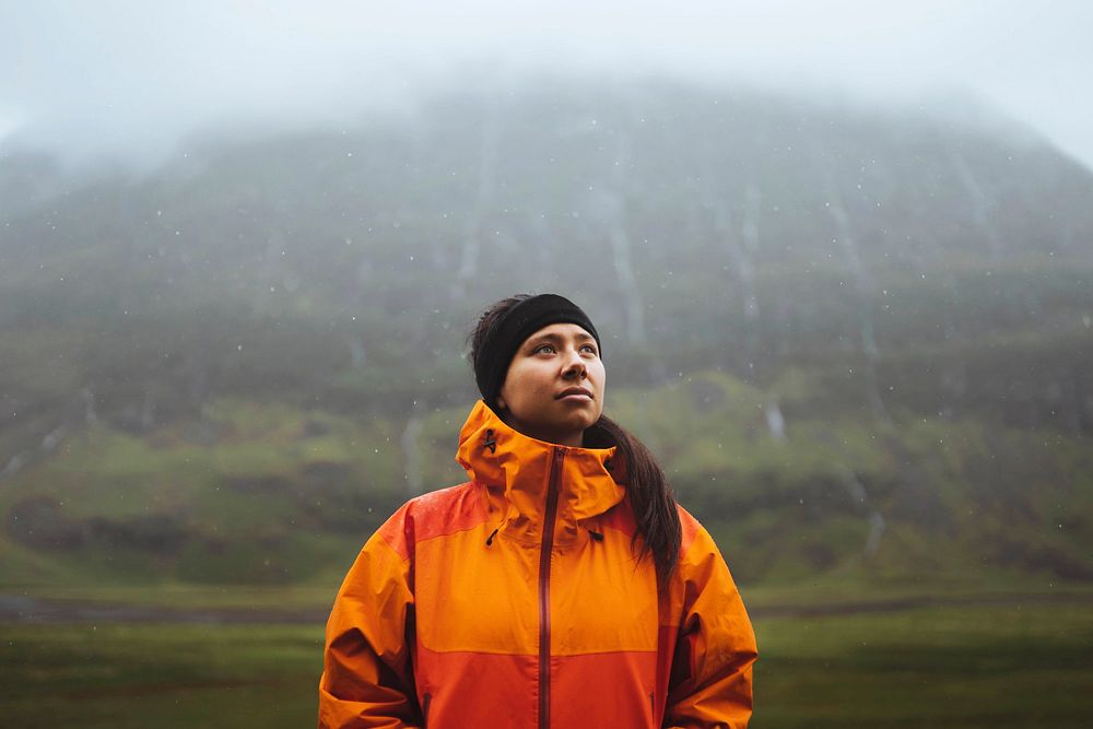 Woman in waterproof jacket while trekking in the highlands
