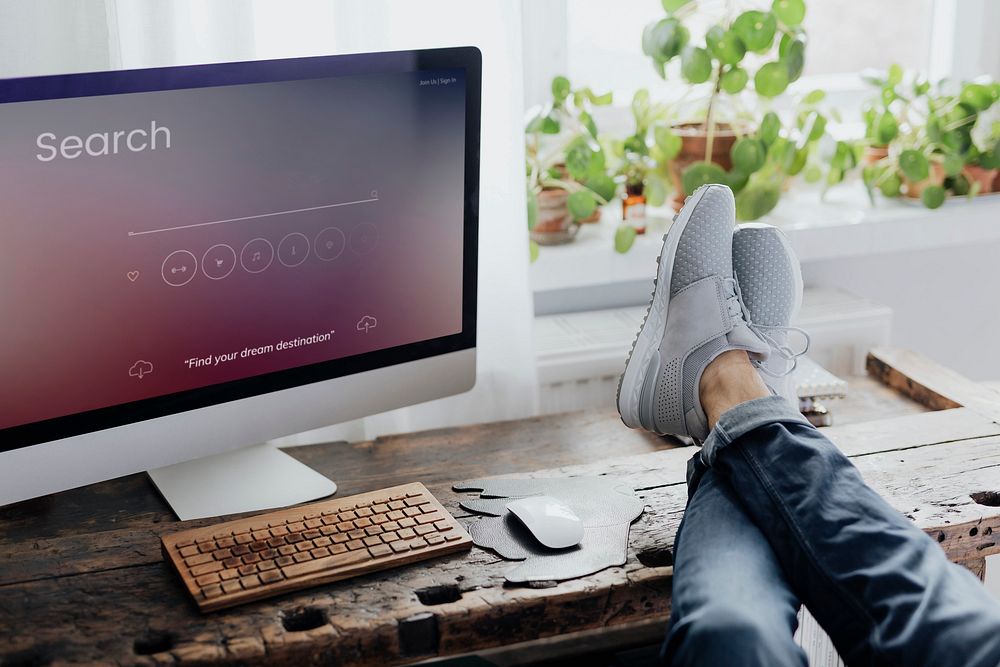 Lazy man putting his feet up on the workstation