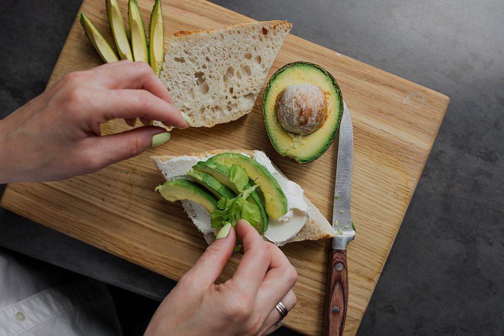 Woman making a healthy avocado toast