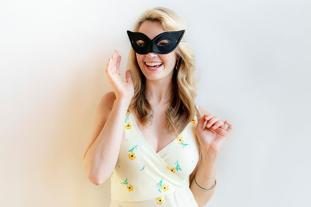 Cheerful woman with mask at the party