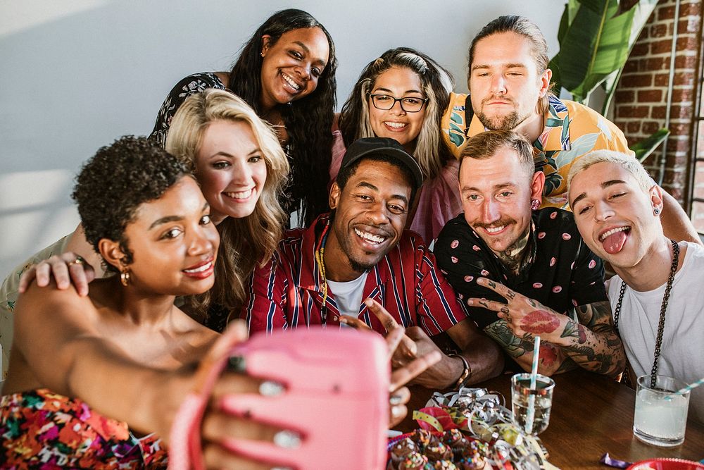 Diverse group of friends taking a selfie at a party