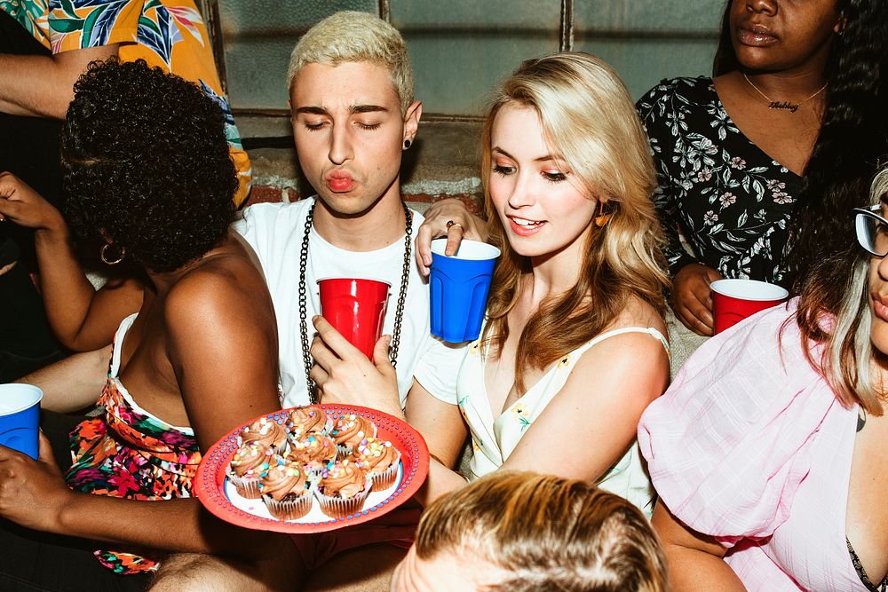 Group of diverse friends enjoy cupcakes at a party