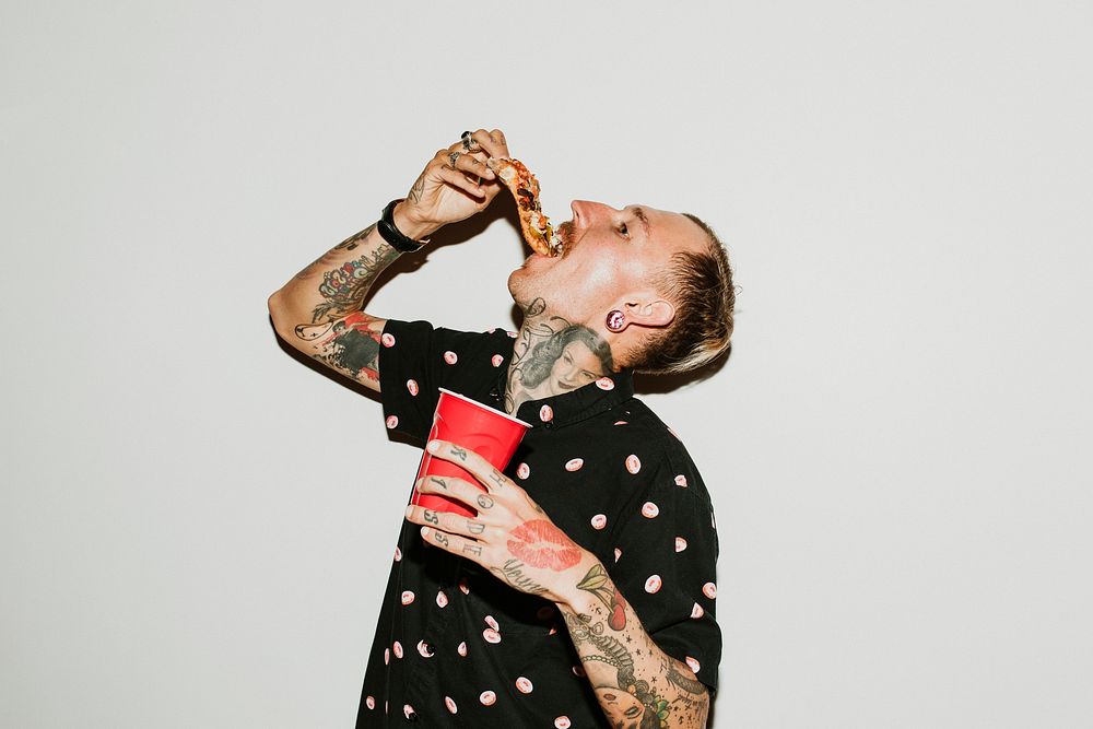 A man eating a pepperoni pizza