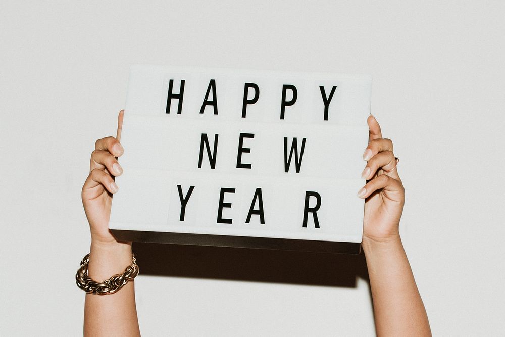 Hands holding a happy new year sign mockup