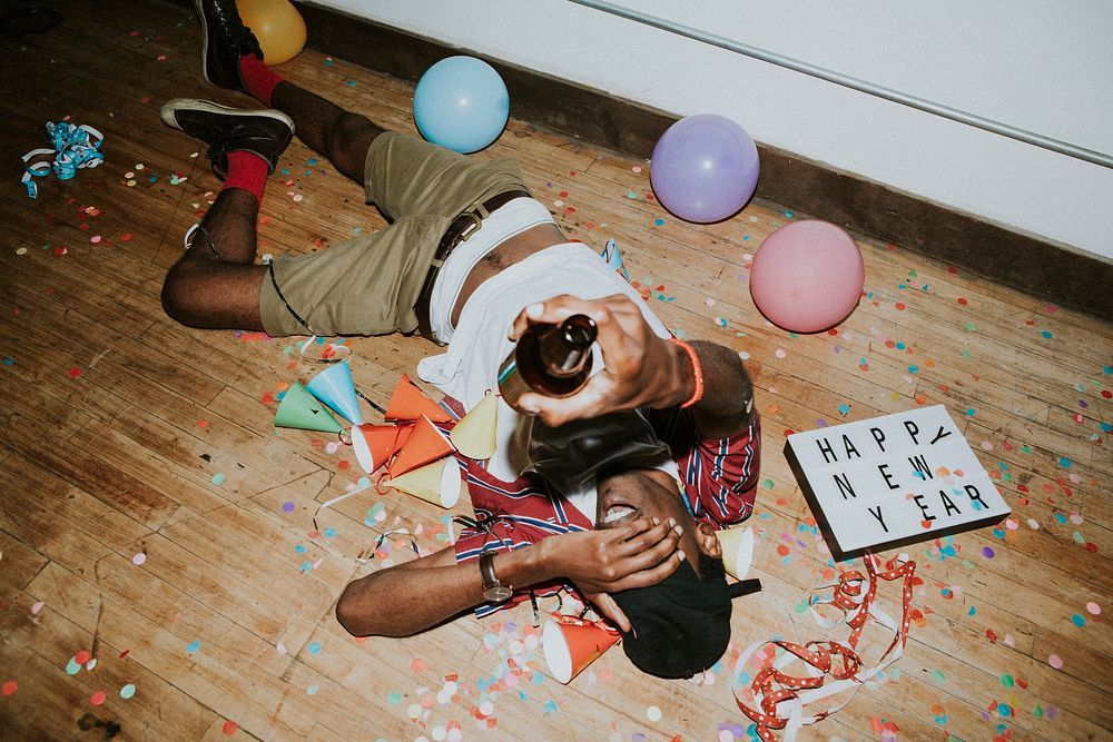 Man laying down on the floor at a party