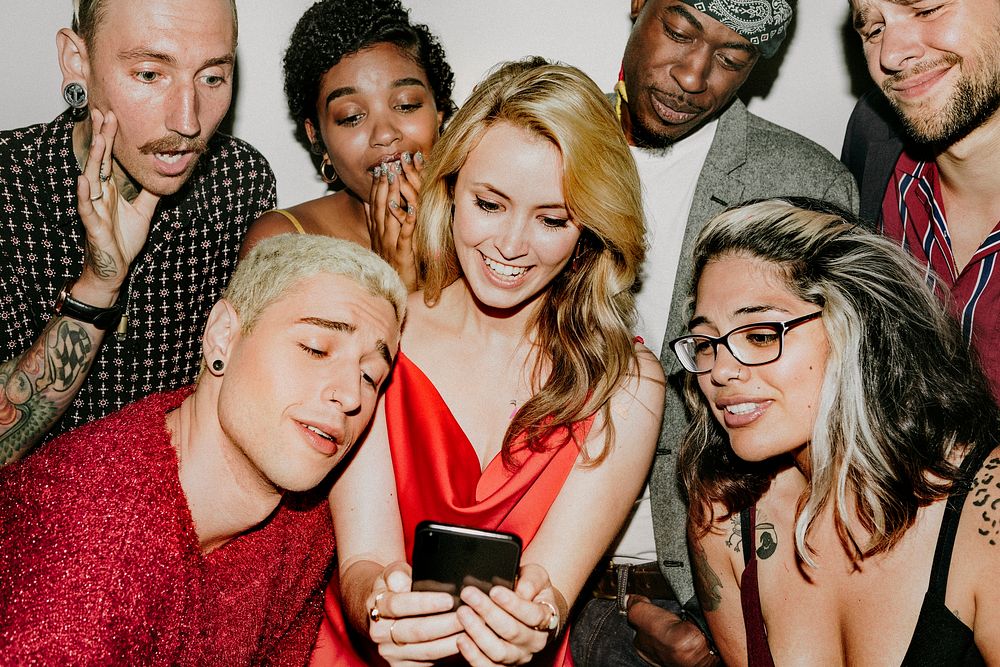 Diverse group of friends checking out a cute photo