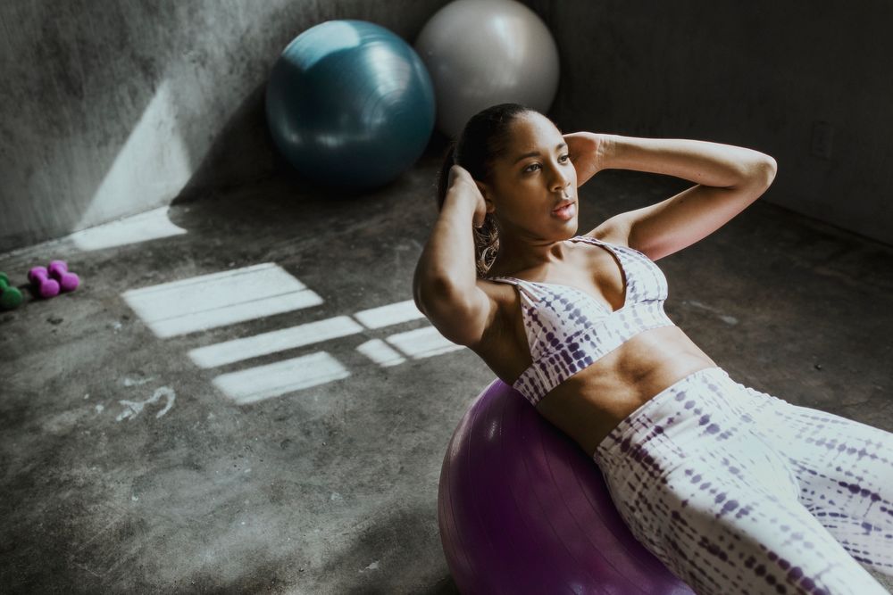 Woman doing sit-ups on a yoga ball 