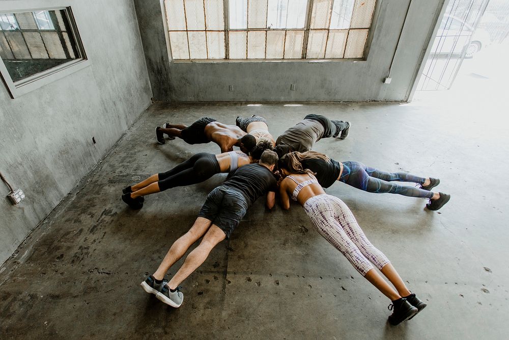Sportive people doing an elbow plank
