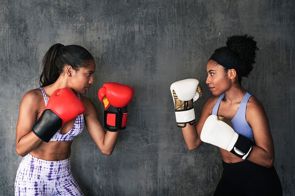 Muscular sportive women ready to box